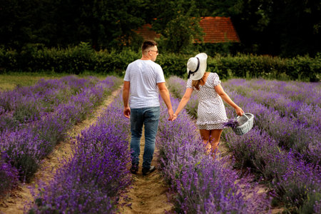 A walk of a young couple on a lavender field, a cozy, quiet and fragrant place for beauty lovers. 2021の写真素材