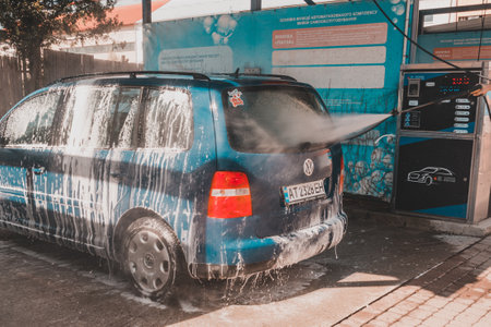 Ivano-Frankivsk, Ukraine August 14, 2020: car wash at a self-service car wash, a man washes his car. 2020のeditorial素材