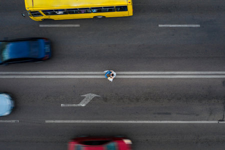 Ivano-Frankivsk, Ukraine September 26, 2020: a couple of brides standing on the roadway, top view....