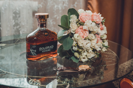 Ivano-Frankivsk, Ukraine August 3, 2019: a bouquet of the bride on a bottle of whiskey. 2020のeditorial素材