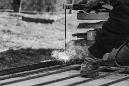 welding of a metal framework, works take place on the street, the process of welding of metal is visible in a close-up. 2020の写真素材