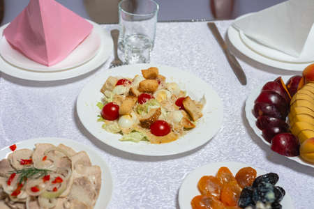 Table setting, food and decorations for important and family events, delicious snacks and hot dishes. 2020の写真素材