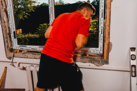 Dolyna, Ukraine July 31, 2020: an employee installs a window frame, installing a plastic window. newのeditorial素材