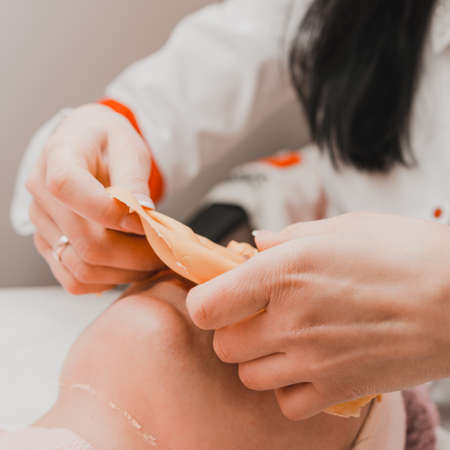 The process of removing the cosmetic golden mass, cosmetic procedures in the salon. newの写真素材