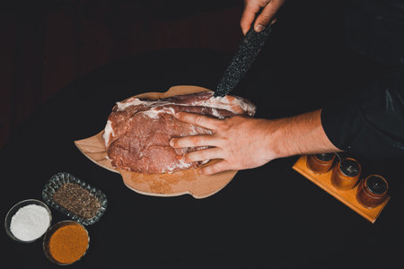 Raw meat, pork neck, the cook prepares the meat for marinating, cuts the lard. 2020の写真素材