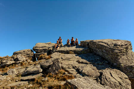 Family on one of the peaks of the Ukrainian Carpathians, parents and children admire the views of...