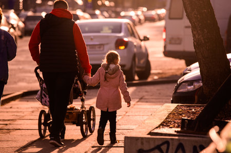 A father with his daughter and a pram returns home after a hard day's work. A walk through the...