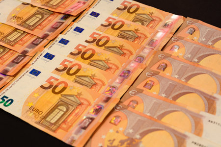 winning the lottery, euro on a black background, texture of money. new