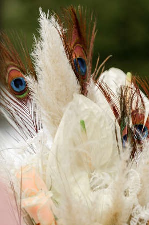 Close up of a bouquet of flowers, stylish work with a peacock feather.の写真素材