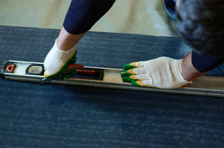 Tapes of roofing material, the master cuts roofing materials from a roll, a waterproofing of a floor...