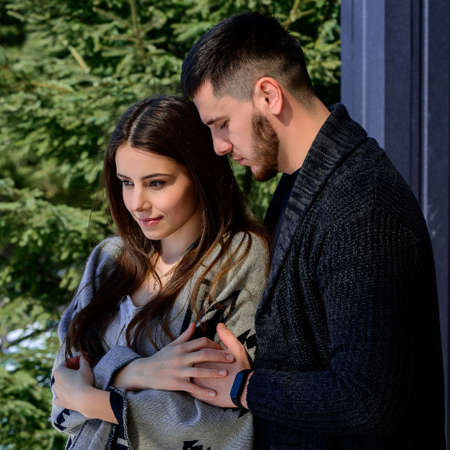 Portrait of a young couple in the backyard near the house, vacation and vacation outside the city.