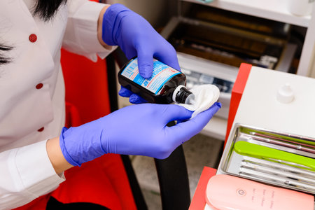 Dolyna, Ukraine March 5, 2021: cosmetologist applies disinfectant solution on cotton swab, cosmetic toolsのeditorial素材