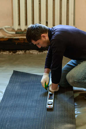 Tapes of roofing material, the master cuts roofing materials from a roll, a waterproofing of a floor...