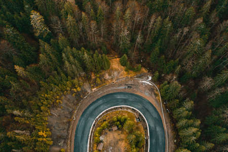 Winding road in the mountains, serpentines and sharp turns on the road, roads in the woods.の写真素材