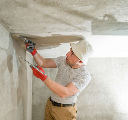 lime plaster for leveling the walls, the master makes repairs in the room, level the walls with...