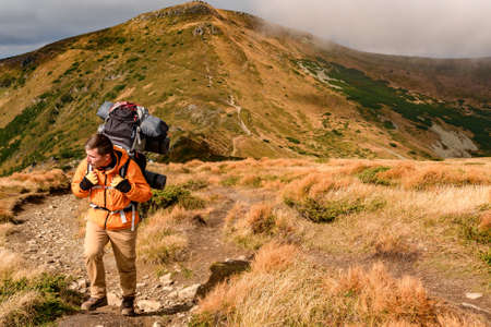 Adventure lifestyle, travel in the mountains with a backpack and overnight stay, trampled trails in...