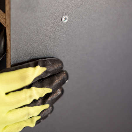 The process of screwing the screw, installing a sliding door wardrobe, components and tools for...