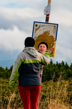 Carpathians, Ukraine September 27, 2021: selfie mirror near Lake Nesamovite in the mountains, a tourist erases from the mirror morning dew, condensation on the mirror, morning in the mountains.のeditorial素材