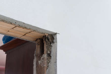 Wooden doorway, replacement and reconstruction of the old door in the room, wooden walls.