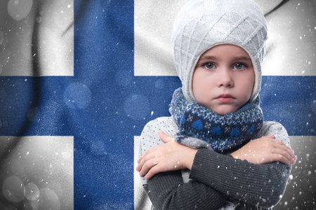 Gas crisis in Finland, Cold winter and high gas prices, the girl is frozen, the child without heat in winter hugs himself with his arms to keep warm.の写真素材