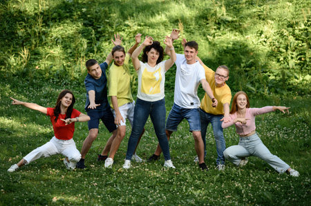 Ivano-Frankivsk, Ukraine, July 14, 2022: school-age teenagers pose for a photo on the sports field, children with their teacher.のeditorial素材