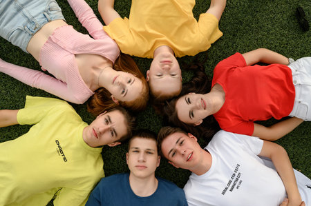 Ivano-Frankivsk, Ukraine, July 14, 2022: happy children made a circle with their heads, bright colors of children's clothes.のeditorial素材