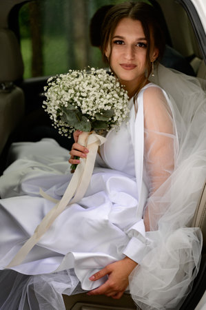 Ivano-Frankivsk, Ukraine June 26, 2021: portrait of the bride, the bride in the car with a bouquet.のeditorial素材