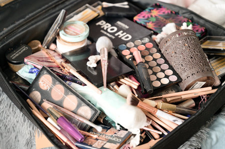 Ivano-Frankivsk, Ukraine June 26, 2021: Make-up artist's bag with cosmetics, randomly scattered cosmetics, dirty brushes from cosmetics.のeditorial素材