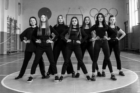 Ivano-Frankivsk, Ukraine May 15, 2021: group photo of girls classmates in the gym, girls in black clothes stand in two rows, black and white photo.のeditorial素材