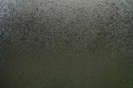 Condensation on the window from a sudden change in temperature outside and inside the house, natural texture on the glass with condensation.の写真素材