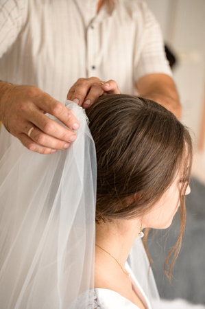 Ivano-Frankivsk, Ukraine June 26, 2021: the morning of the bride with her father, dad puts a cover on his head.のeditorial素材