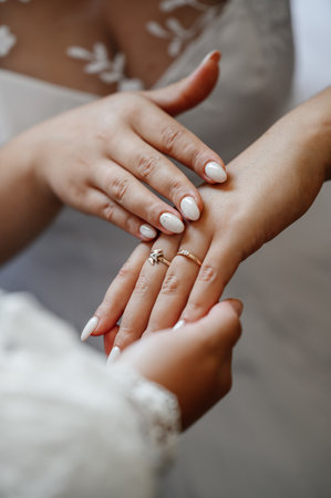 Gold rings of newlyweds, wedding accessories, rings close-up, two rings on the fingers of the bride.の写真素材