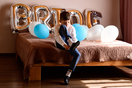 Ivano-Frankivsk, Ukraine August 1, 2021: The bride's room is decorated with balls for the wedding day, the boy is sittingのeditorial素材