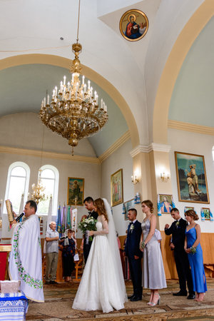 Ivano-Frankivsk, Ukraine August 1, 2021:a wedding in a Ukrainian church, the sacrament of the wedding of the bride and groom in the church.のeditorial素材