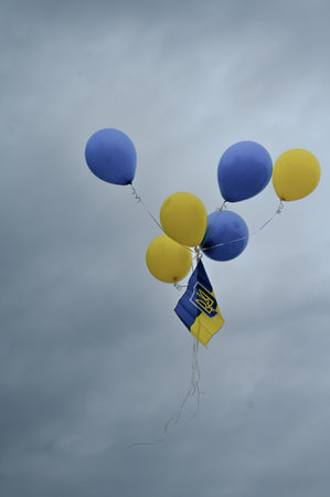 balls in the style of the Ukrainian flag rise with the flag of Ukraine to the sky, balls in the sky.の写真素材