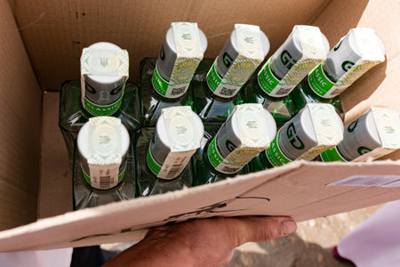 Ivano-Frankivsk, Ukraine July 31, 2022: Vodka box with Ukrainian excise tax, Ukrainian coat of arms trident on bottle, close-up of vodka box.のeditorial素材