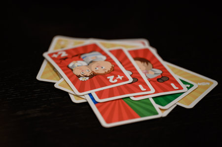 Ivano-Frankivsk, Ukraine November 20, 2022: Children play board games, playing cards with children on birthday holidays, educational games, Cards Uno.のeditorial素材