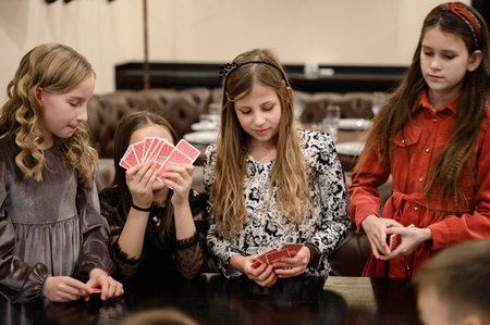 Ivano-Frankivsk, Ukraine November 20, 2022: Children play board games, playing cards with children...