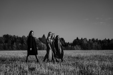 Ivano-Frankivsk, Ukraine October 14, 2022: girls classmates hold hands and go to the rhythm, autumn walk of friends.のeditorial素材