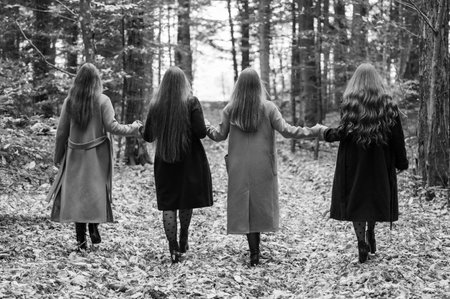 girls classmates hold hands and go to the rhythm, autumn walk of friends.のeditorial素材