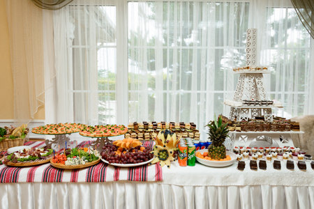 Exquisite festive table with sweets and fruits, celebration and treat with sweets.