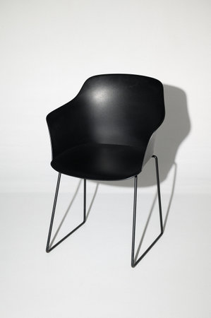 Elegant black chair on a white background in a photo studio, a chair for a photo shoot, copy space and free space for text.の写真素材