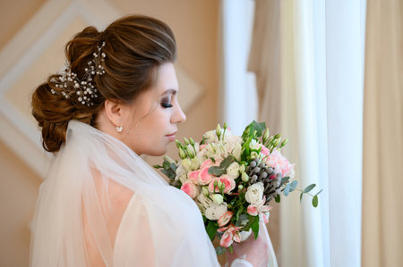 Nadvirna, Ukraine on November 22, 2022: a portrait of the bride in the profile with flowers, bride in Ukraine.のeditorial素材
