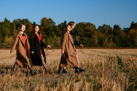 Ivano-Frankivsk, Ukraine October 14, 2022: girls classmates hold hands and go to the rhythm, autumn walk of friends.のeditorial素材
