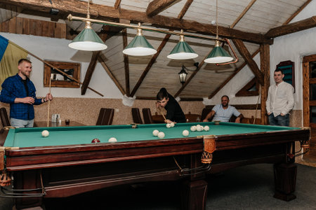Ivano-Frankivsk, Ukraine November 20, 2021: Playing billiards, men playing billiards as amateurs, sports board game, active recreation.のeditorial素材
