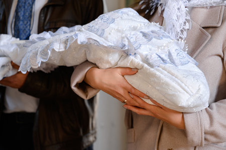 The moments of baptism of the child in the temple of God, Christian traditions, godparents undress...