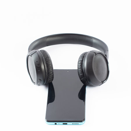 Wireless headphones with a phone on a white background, in-ear and gaming headphones.