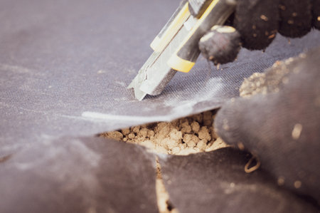 Cutting agricultural fiber with a clerical knife close-up.