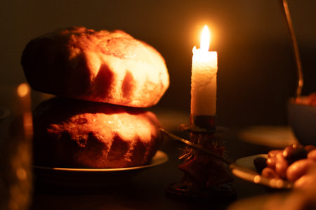 Christmas Eve in a Ukrainian family. Kutia on the table and a yellow lighted candle.