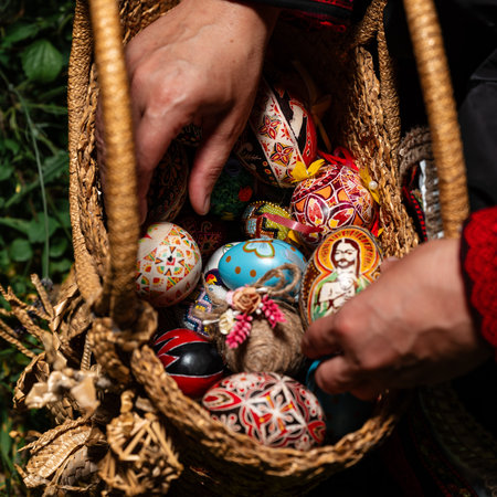 Ivano-Frankivsk, Ukraine August 14, 2023:Ukrainian Easter eggs in a wicker basket made of straw, Ukrainian art and traditions, eggs in a straw basket.の写真素材